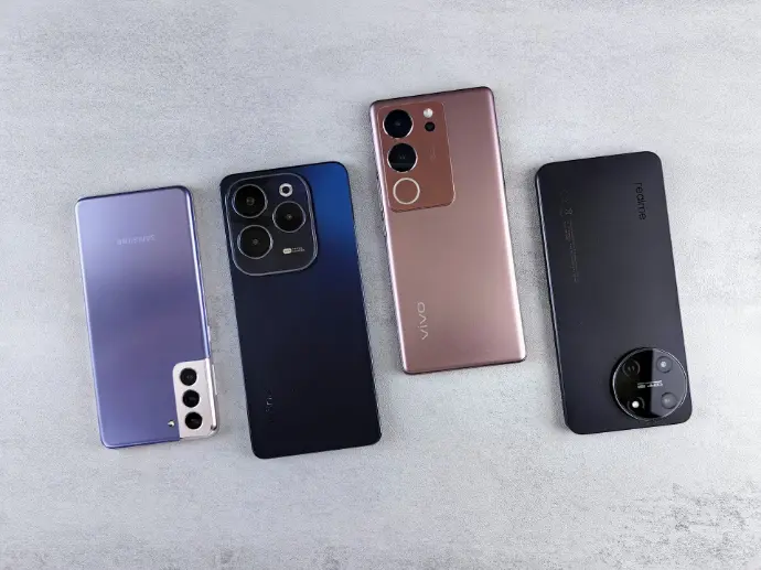 a group of four cell phones sitting next to each other