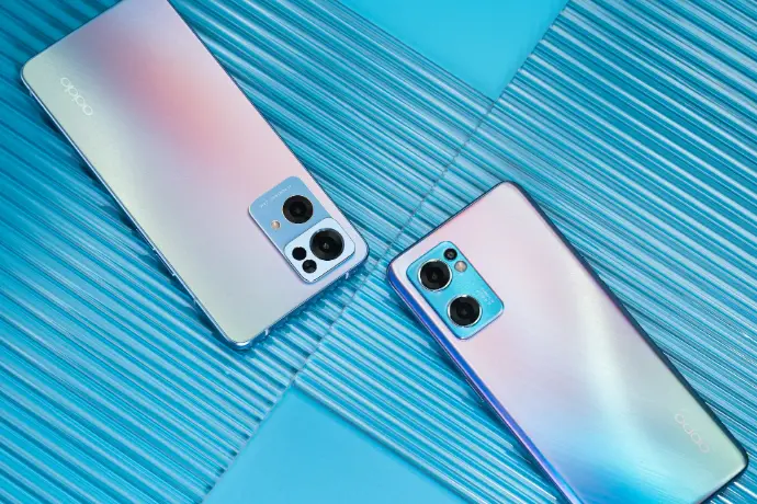 two new cell phones are laying side by side